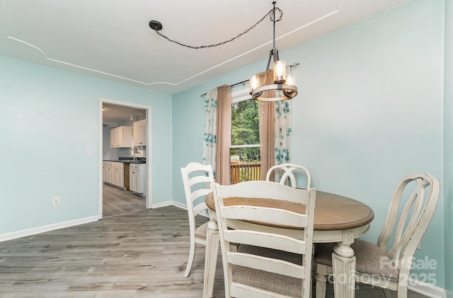 3884 Snider Cir, Hickory, NC 28602 - dining space with a chandelier, light wood finished floors, and baseboards