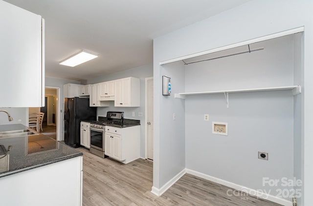 3884 Snider Cir, Hickory, NC 28602 - kitchen featuring stainless steel gas stove, a sink, freestanding refrigerator, light wood finished floors, and white cabinetry