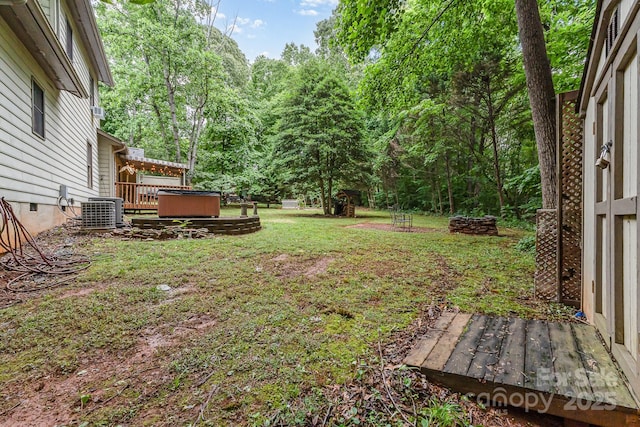 3884 Snider Cir, Hickory, NC 28602 - view of grassy yard with a hot tub, cooling unit, and a deck