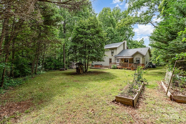 3884 Snider Cir, Hickory, NC 28602 - view of grassy yard featuring a vegetable garden and a wooden deck
