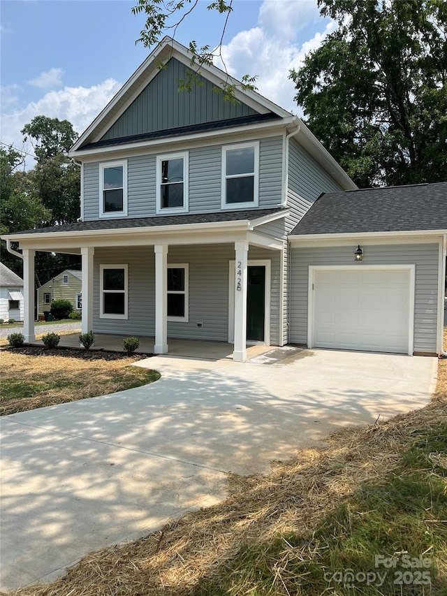 242 N Ave, Troutman, NC 28166 - view of front of home with driveway, a garage, a porch, and board and batten siding