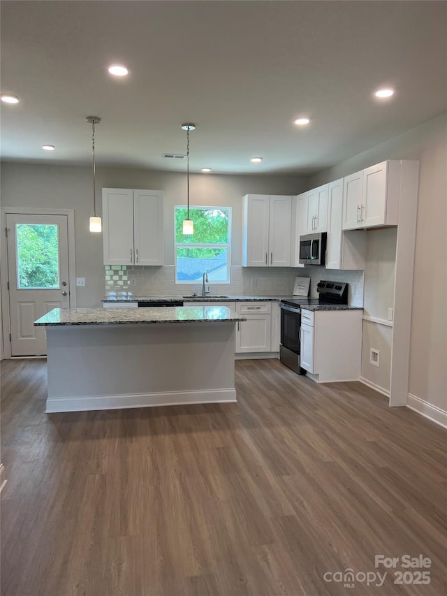 242 N Ave, Troutman, NC 28166 - kitchen featuring stainless steel appliances, a sink, white cabinetry, healthy amount of natural light, and recessed lighting
