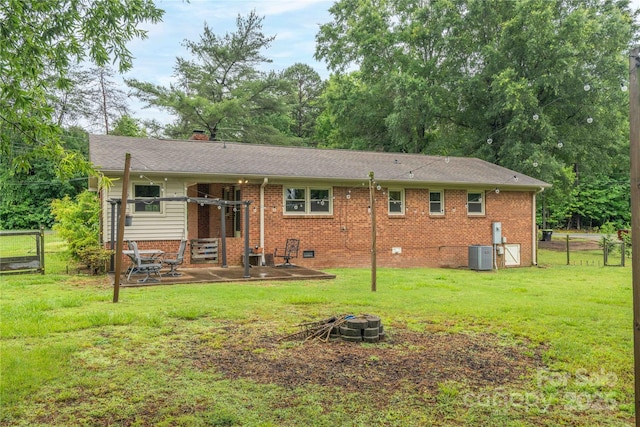 166 Stephanie Dr, Lexington, NC 27295 - rear view of house with an outdoor fire pit, a patio area, central AC, a chimney, and brick siding