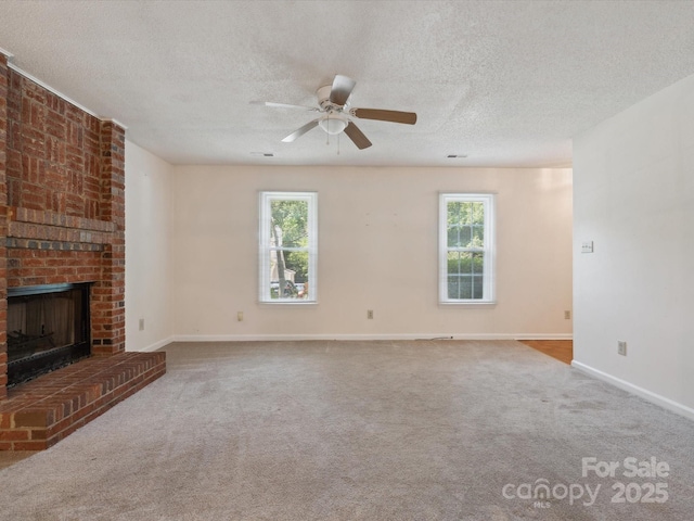 3313 Fortis Ln, Matthews, NC 28105 - unfurnished living room with a textured ceiling, plenty of natural light, a fireplace, baseboards, and a ceiling fan
