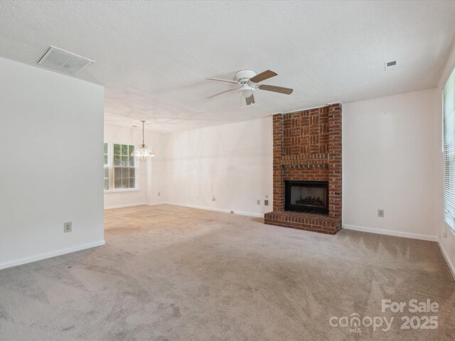 3313 Fortis Ln, Matthews, NC 28105 - unfurnished living room featuring a chandelier, a fireplace, a ceiling fan, carpet, and baseboards