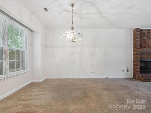 3313 Fortis Ln, Matthews, NC 28105 - unfurnished dining area with carpet floors, a chandelier, a brick fireplace, and baseboards