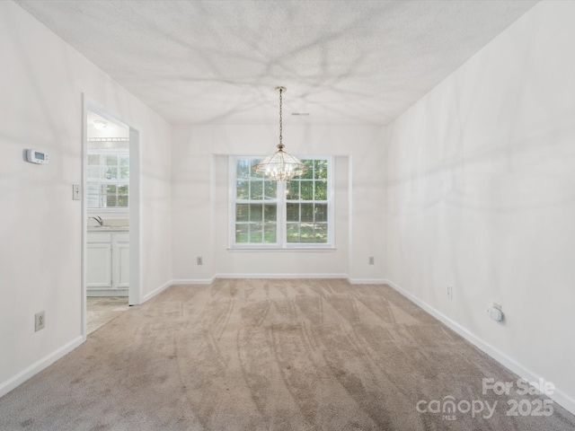 3313 Fortis Ln, Matthews, NC 28105 - unfurnished dining area with carpet floors, a chandelier, a sink, baseboards, and a textured ceiling