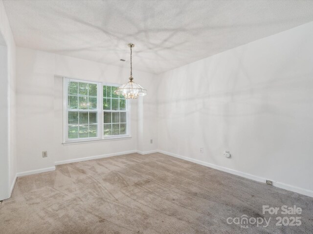 3313 Fortis Ln, Matthews, NC 28105 - empty room featuring carpet flooring, baseboards, and a chandelier