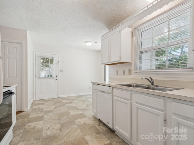 3313 Fortis Ln, Matthews, NC 28105 - kitchen with dishwasher, a sink, a textured ceiling, stove, and white cabinets