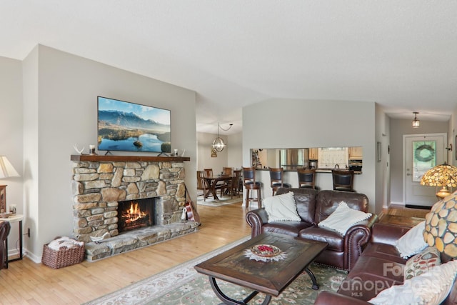 44 Falls Creek Rd, Pisgah Forest, NC 28768 - living room featuring wood finished floors, lofted ceiling, and a fireplace