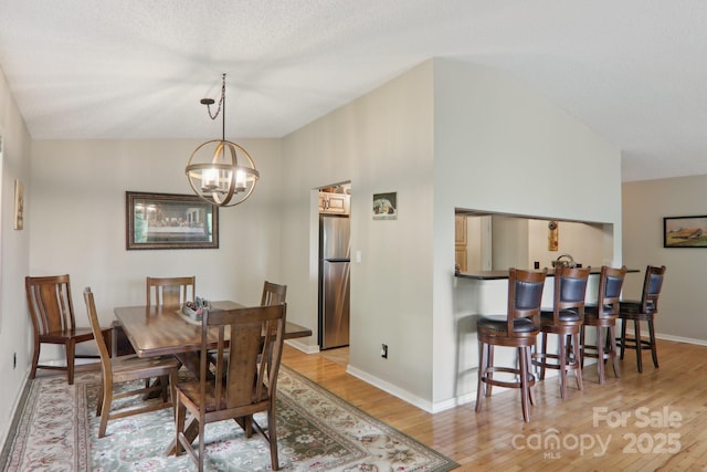 44 Falls Creek Rd, Pisgah Forest, NC 28768 - dining room with light wood finished floors, a chandelier, and lofted ceiling