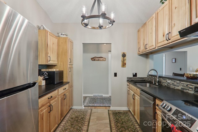 44 Falls Creek Rd, Pisgah Forest, NC 28768 - kitchen with stainless steel appliances, dark countertops, a chandelier, light brown cabinetry, and tasteful backsplash