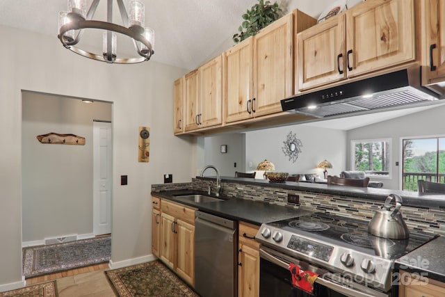 44 Falls Creek Rd, Pisgah Forest, NC 28768 - kitchen with appliances with stainless steel finishes, under cabinet range hood, light brown cabinetry, vaulted ceiling, and dark countertops