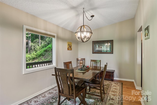 44 Falls Creek Rd, Pisgah Forest, NC 28768 - dining room with a chandelier, a textured ceiling, and wood finished floors