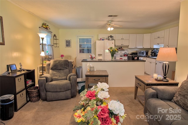 252 Chuckwood Rd, Mooresville, NC 28117 - living area with ceiling fan, light carpet, and crown molding