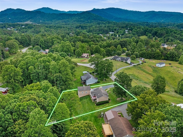 321 Jupiter Rd, Weaverville, NC 28787 - aerial overview of property's location with a heavily wooded area, a mountainous background, and property parcel outlined