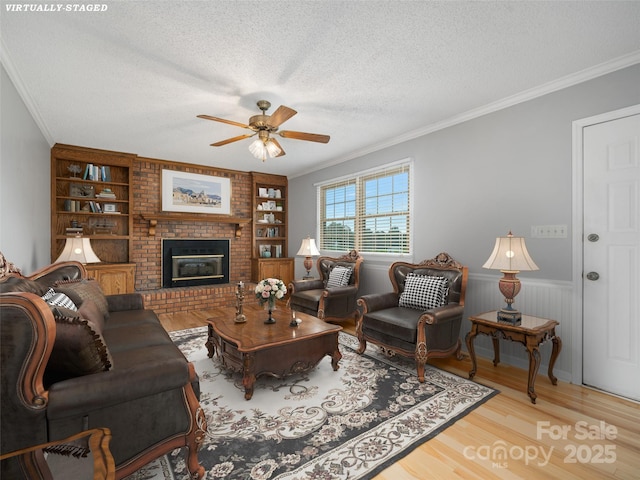 321 Jupiter Rd, Weaverville, NC 28787 - living room with a textured ceiling, ornamental molding, a ceiling fan, wood finished floors, and wainscoting