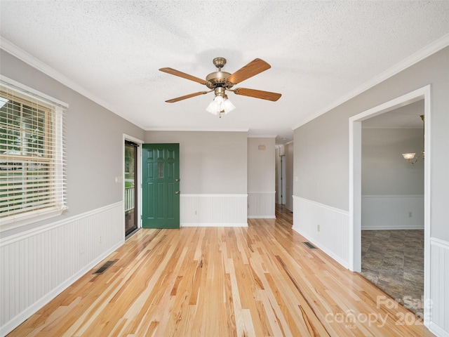 321 Jupiter Rd, Weaverville, NC 28787 - spare room featuring a wainscoted wall, a textured ceiling, wood finished floors, ornamental molding, and a ceiling fan
