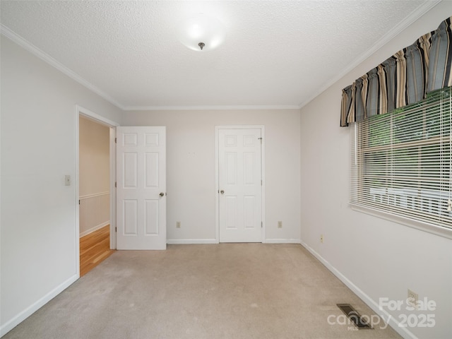 321 Jupiter Rd, Weaverville, NC 28787 - unfurnished bedroom featuring crown molding, light carpet, baseboards, and a textured ceiling
