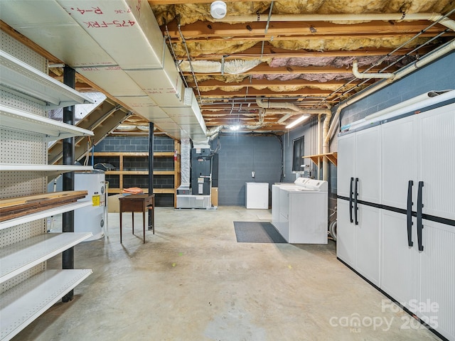 321 Jupiter Rd, Weaverville, NC 28787 - unfinished below grade area with washing machine and clothes dryer, heating unit, electric water heater, and concrete block wall