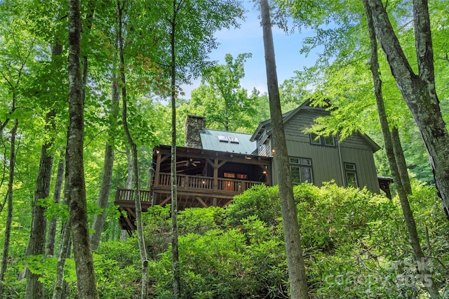 151 Sanctuary Dr, Burnsville, NC 28714 - back of property featuring a wooden deck, a chimney, metal roof, and a standing seam roof