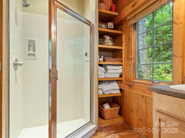 151 Sanctuary Dr, Burnsville, NC 28714 - bathroom with a stall shower, vanity, wood finished floors, and plenty of natural light