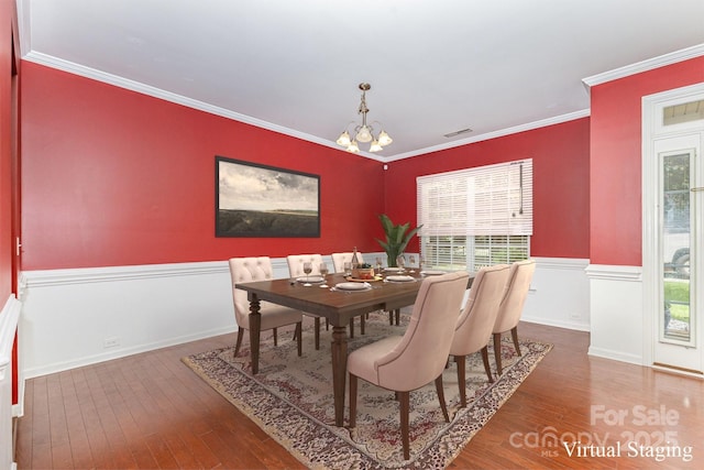 10105 Community House Rd, Charlotte, NC 28277 - dining space featuring a wainscoted wall, a chandelier, wood-type flooring, and ornamental molding