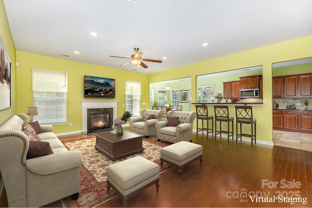 10105 Community House Rd, Charlotte, NC 28277 - living area featuring a ceiling fan, hardwood / wood-style floors, a fireplace with flush hearth, plenty of natural light, and recessed lighting