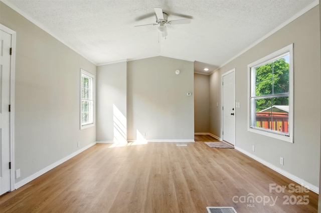 1016 S D Ave, Maiden, NC 28650 - unfurnished living room with a ceiling fan, light wood-style flooring, plenty of natural light, a textured ceiling, and crown molding