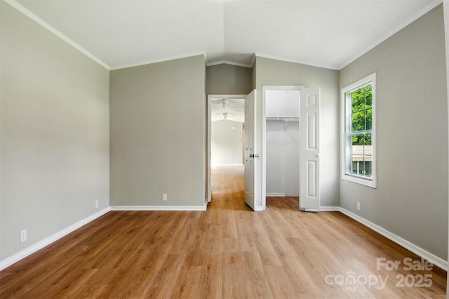1016 S D Ave, Maiden, NC 28650 - unfurnished bedroom featuring light wood finished floors, baseboards, crown molding, vaulted ceiling, and a closet