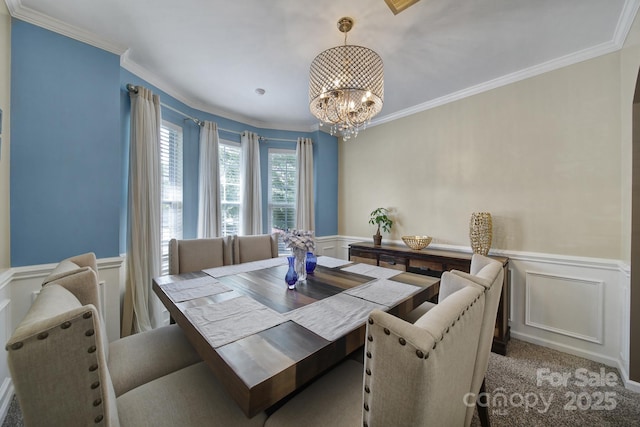 920 Old Forester Ln, Charlotte, NC 28214 - dining room featuring a decorative wall, wainscoting, a chandelier, crown molding, and carpet floors