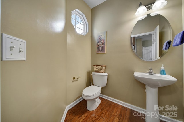 920 Old Forester Ln, Charlotte, NC 28214 - bathroom with baseboards, toilet, and wood finished floors