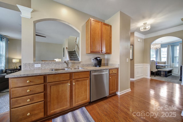 920 Old Forester Ln, Charlotte, NC 28214 - kitchen featuring dishwasher, a sink, wood finished floors, wainscoting, and crown molding