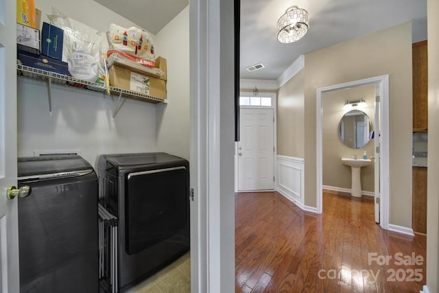 920 Old Forester Ln, Charlotte, NC 28214 - washroom featuring washer and clothes dryer, wood-type flooring, baseboards, and crown molding
