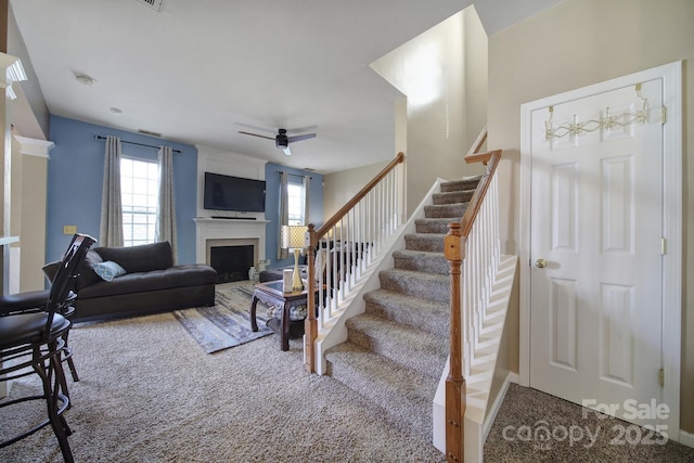 920 Old Forester Ln, Charlotte, NC 28214 - carpeted living room with stairway, a fireplace, and ceiling fan