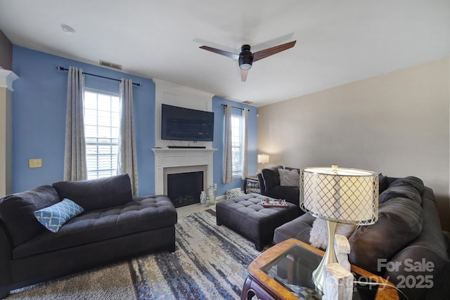 920 Old Forester Ln, Charlotte, NC 28214 - living room featuring plenty of natural light, a ceiling fan, and a fireplace with flush hearth