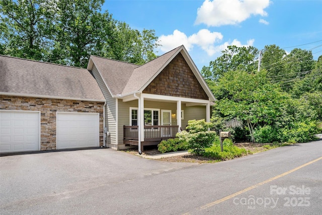 1 Teresa Way, Black Mountain, NC 28711 - view of front of property featuring a garage, covered porch, asphalt driveway, roof with shingles, and stone siding