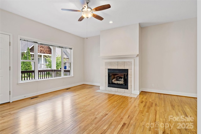 1 Teresa Way, Black Mountain, NC 28711 - unfurnished living room featuring wood finished floors, ceiling fan, baseboards, a tiled fireplace, and recessed lighting