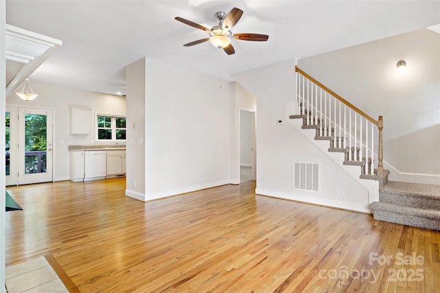 1 Teresa Way, Black Mountain, NC 28711 - unfurnished living room with stairs, ceiling fan, light wood finished floors, and baseboards
