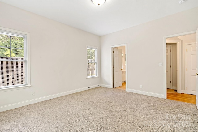 1 Teresa Way, Black Mountain, NC 28711 - unfurnished bedroom featuring multiple windows, baseboards, and light colored carpet
