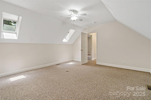 1 Teresa Way, Black Mountain, NC 28711 - additional living space featuring a skylight, carpet, a ceiling fan, vaulted ceiling, and baseboards