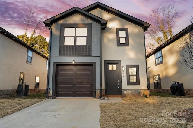 2813 Ava Ave, Charlotte, NC 28208 - view of front of home featuring an attached garage, stucco siding, concrete driveway, and central air condition unit