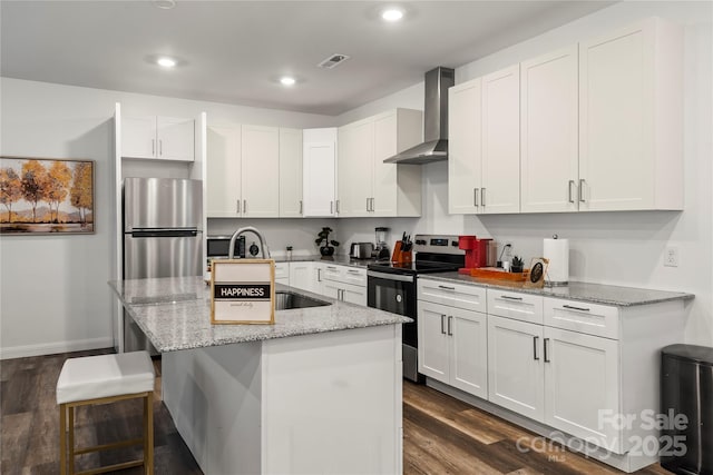 2813 Ava Ave, Charlotte, NC 28208 - kitchen featuring stainless steel appliances, wall chimney exhaust hood, dark wood-style floors, a center island with sink, and recessed lighting