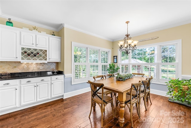 738 Rocky Hollow Trl, Clover, SC 29710 - dining room featuring dark wood-style floors, a chandelier, a bar, baseboards, and ornamental molding