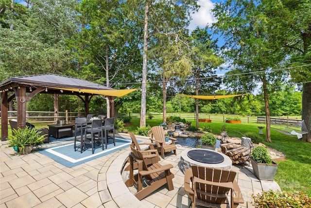 738 Rocky Hollow Trl, Clover, SC 29710 - view of patio / terrace with an outdoor fire pit, a gazebo, view of wooded area, and outdoor dining space