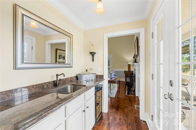 738 Rocky Hollow Trl, Clover, SC 29710 - bar area featuring a sink, dark wood-style flooring, ornamental molding, a fireplace, and beverage cooler