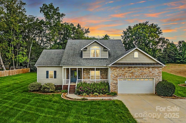 117 Chandler Dr, Mocksville, NC 27028 - view of front facade with a porch, concrete driveway, stone siding, a garage, and roof with shingles