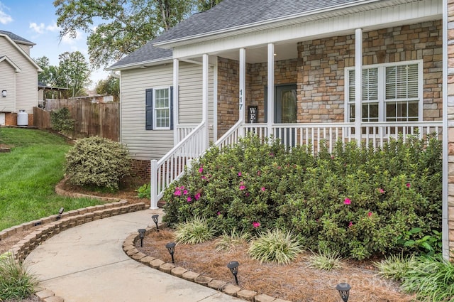 117 Chandler Dr, Mocksville, NC 27028 - property entrance featuring roof with shingles, stone siding, and a porch