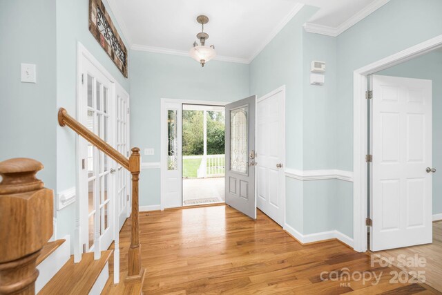 117 Chandler Dr, Mocksville, NC 27028 - foyer entrance with light wood-style flooring, ornamental molding, stairs, and baseboards