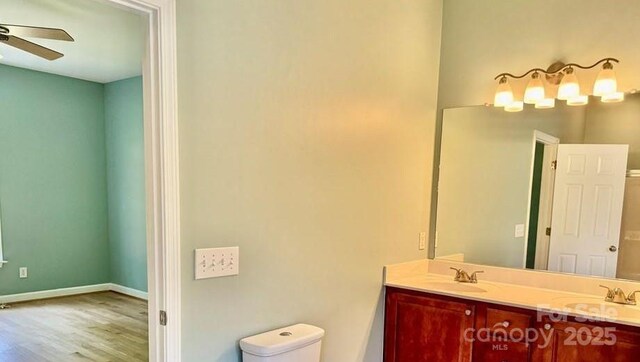 117 Chandler Dr, Mocksville, NC 27028 - full bathroom with double vanity, ceiling fan, wood finished floors, toilet, and baseboards